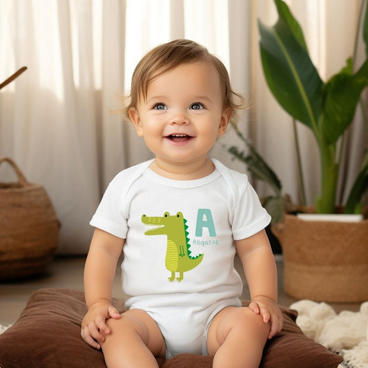 a baby sitting on the floor wearing a white shirt with a green alligator on it